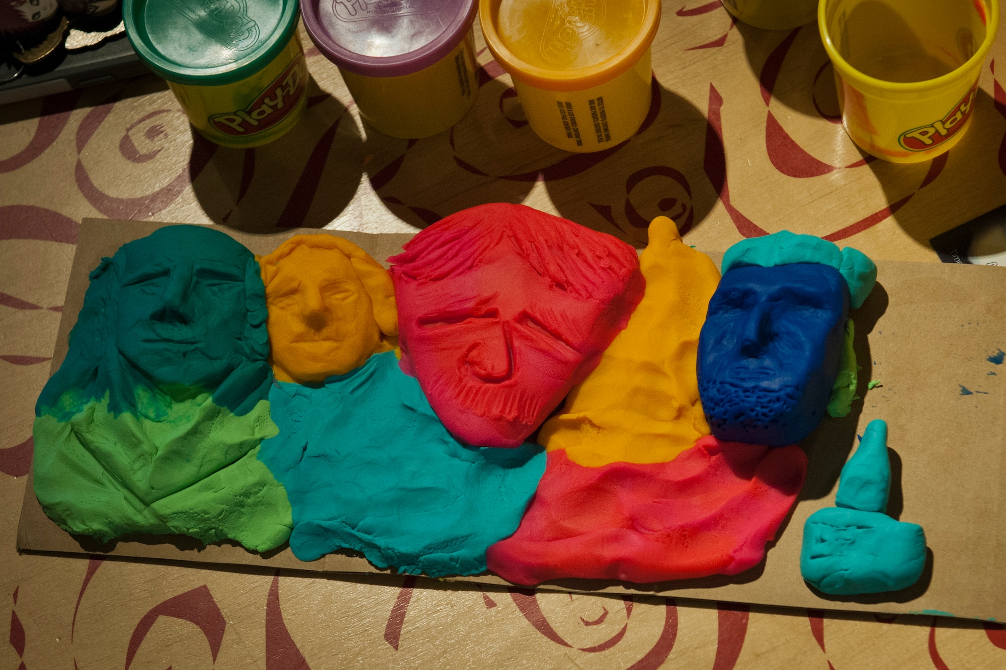 PETERSON AIR FORCE BASE, Colo. -- Contestants create an abstract representation of the famous rock sculpture with only the supplies provided by the Peterson AFB Chapel at the first ever Mount Rushmore building competition at the Eclipse Cyber Café, July 8, 2015. Contestants included Airman 1st Class Jessica Griffin, 21st Aerospace Medical Squadron public health specialist; Alex Griffin, spouse; Airman 1st Class Hersey Mayo, 21st Aerospace Medical Squadron public health specialist; and Airman Faith Aviles, 21st Force Support Squadron food service specialist. (U.S. Air Force photo by Airman 1st class Rose Gudex)