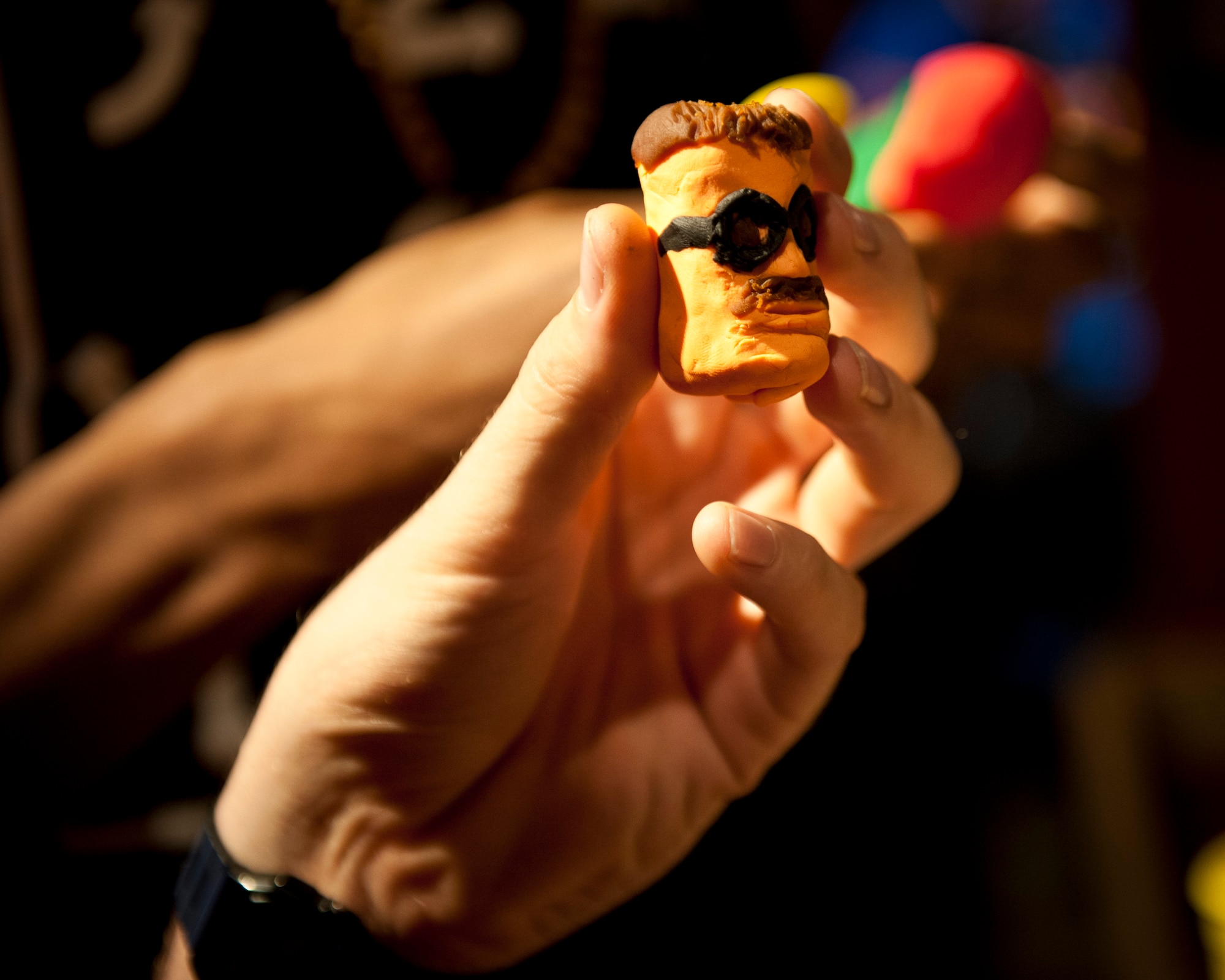 PETERSON AIR FORCE BASE, Colo. – Airman 1st Class Matthew Towles, 21st Dental Squadron dental lab technician, uses skilled hands to create fine details on the tiny Theodore Roosevelt for his team’s entry at the Mount Rushmore building contest held at the Eclipse Cyber Café, July 8, 2015. Each team of four (or less) had to create a version of Mount Rushmore in the chapel sponsored event, with only modeling clay and the small plastic tools provided. (U.S. Air Force photo by Airman 1st Class Rose Gudex)