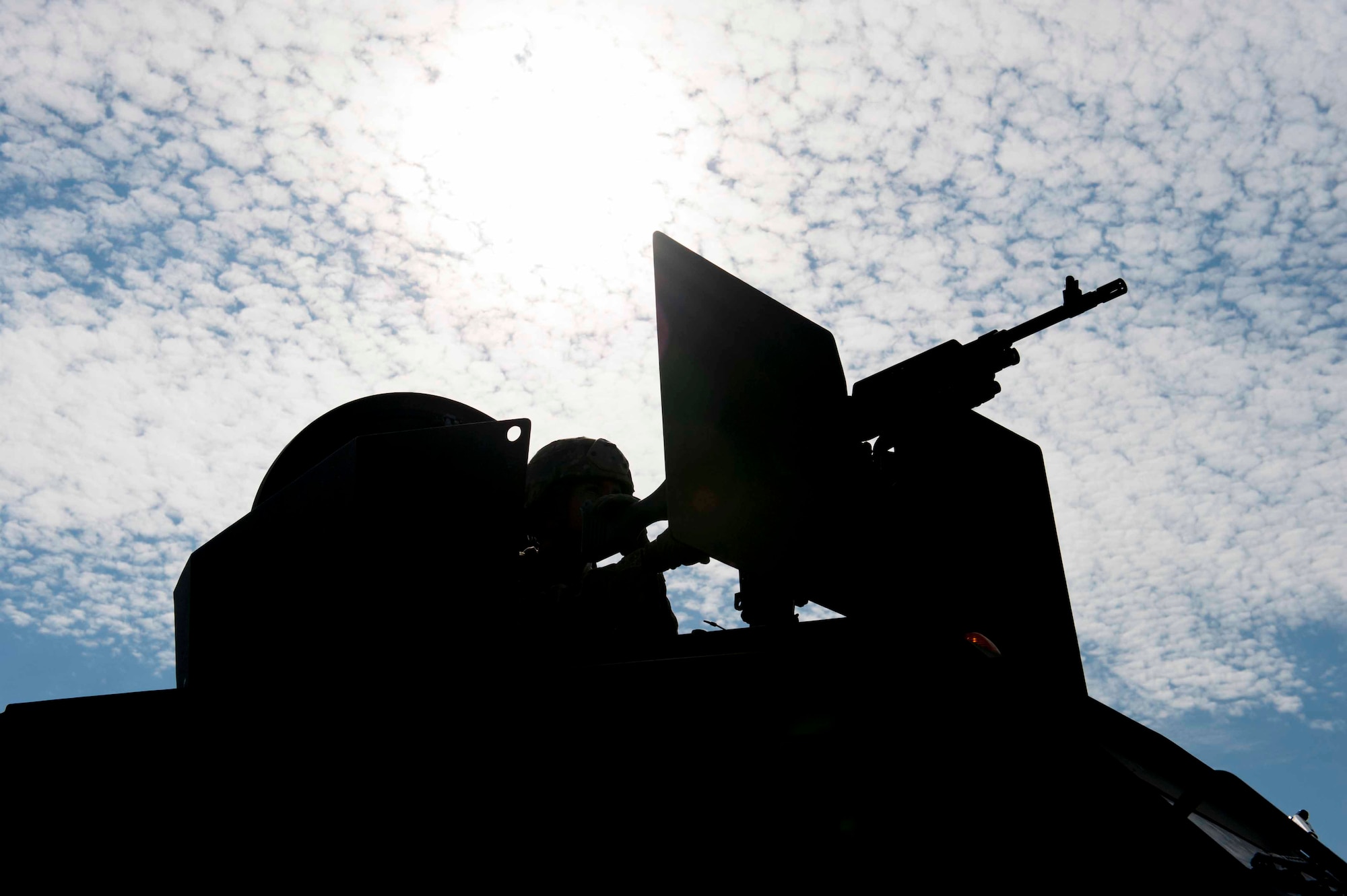 A 91st Security Forces Group member guards a launch facility from the turret of a Humvee near Donnybrook, N.D., June 29, 2015. After suppressing personnel acting as simulated aggressors, Airmen participating in the exercise set up a secure perimeter and conducted thorough sweeps of the area. (U.S. Air Force photo/Airman 1st Class Sahara L. Fales)