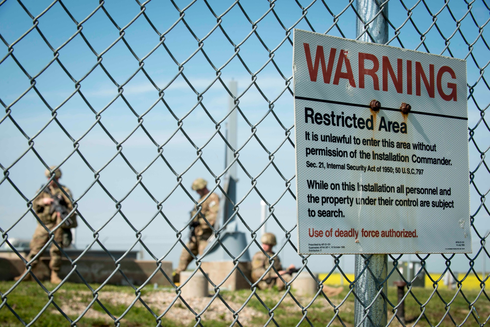 91st Security Forces Group members secure a launch facility during an exercise near Donnybrook, N.D., June 29, 2015. After suppressing personnel acting as simulated aggressors, Airmen participating in the exercise set up a secure perimeter and conducted thorough sweeps of the area. (U.S. Air Force photo/Airman 1st Class Sahara L. Fales)