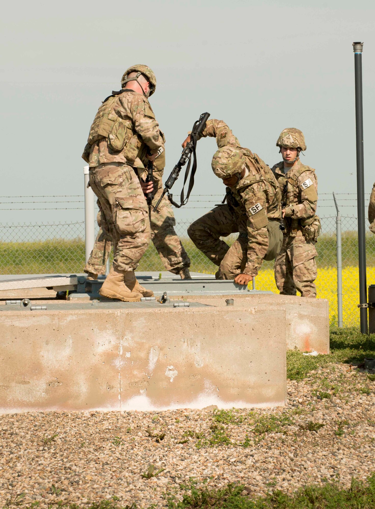 91st Security Forces Group members secure a launch facility during an exercise near Donnybrook, N.D., June 29, 2015. Airmen from 219th Security Forces Squadron and 791st Missile Security Forces Squadron worked together to apprehend personnel dressed as simulated aggressors and recapture a launch facility. (U.S. Air Force photo/Airman 1st Class Sahara L. Fales)