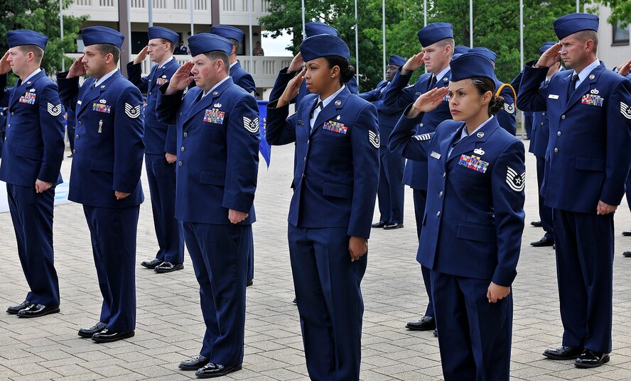 NCO Academy Airmen salute during a retreat ceremony July 9, 2015, at Kapaun, Germany. Since 1947, the birth year of the United States Air Force, Airmen have performed retreat ceremonies at the end of every official duty day. (U.S. Air Force photo/Airman 1st Class Tryphena Mayhugh)