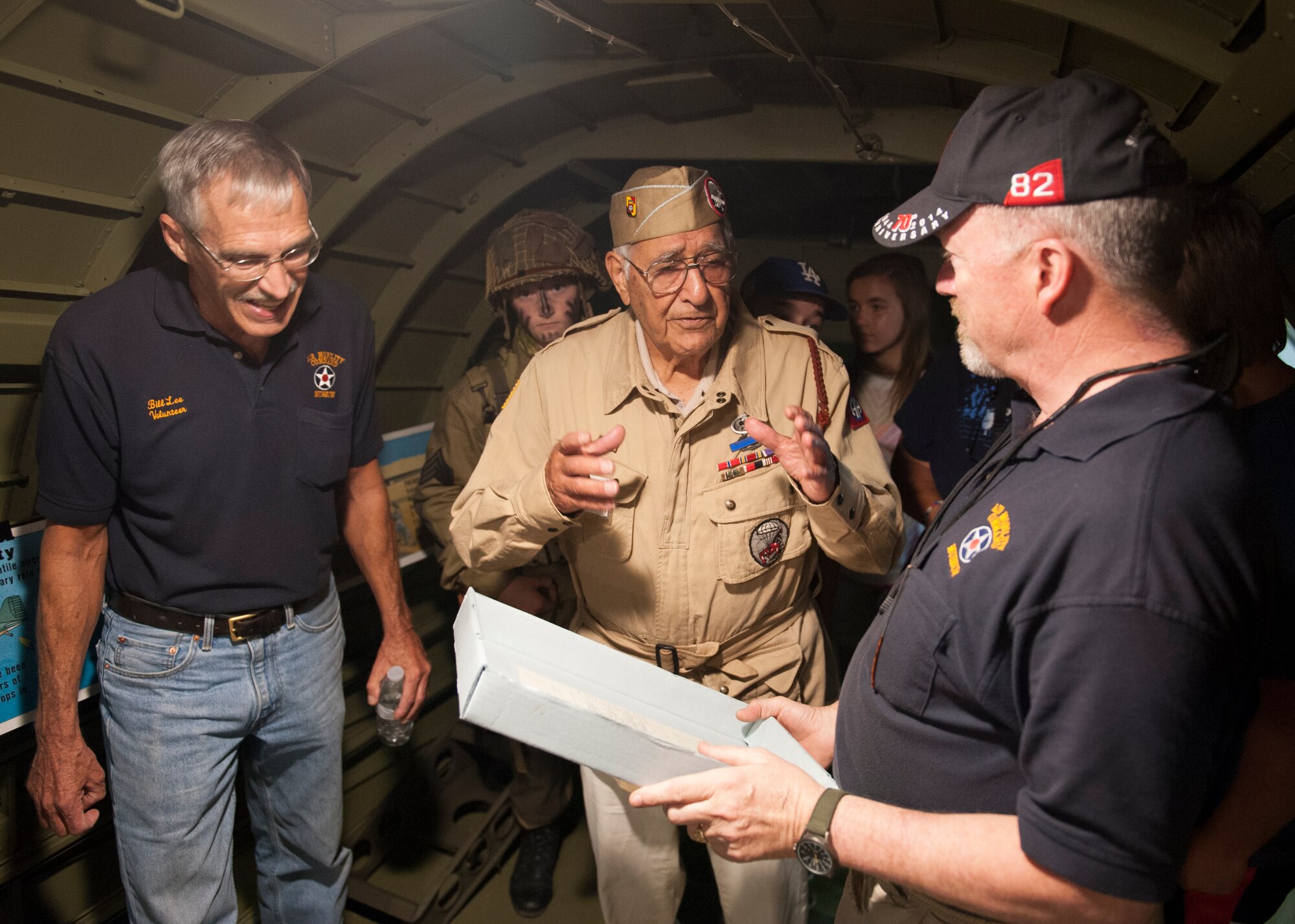 Joe Morettini, center, talks with Air Mobility Command Museum volunteers, Bill Lee and Bob Leicht, inside a C-47A Skytrain July 9, 2015, at the AMC Museum on Dover Air Force Base, Del. Morettini last visited this aircraft in the early 1990s. (U.S. Air Force photo/Airman 1st Class Zachary Cacicia)