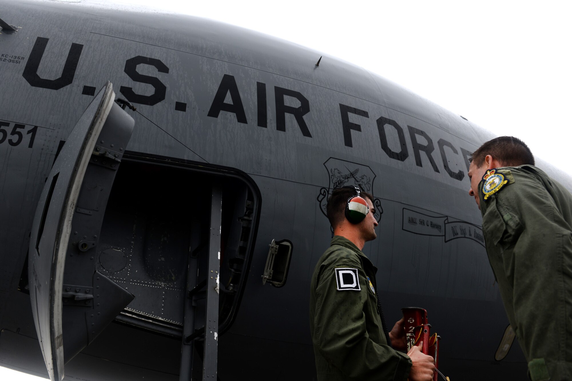 U.S. Air Force Benjamin Kline, right, 100th Air Refueling Wing KC-135 Stratotanker pilot and command post chief from Taylor, Mich., greets U.S. Air Force Senior Airman Justin Estergard, 100th Maintenance Squadron KC-135 Stratotanker crew chief from Callaway, Neb., after landing June 24, 2015, during air refueling familiarization training on Kecskemét air base, Hungary. Hungarian, U.S. and Swedish air force personnel met for a two-week familiarization period enabling the Hungarian JAS-39 Gripen pilots to successfully perform air refueling for the first time. (U.S. Air Force photo by Senior Airman Kate Thornton/Released)