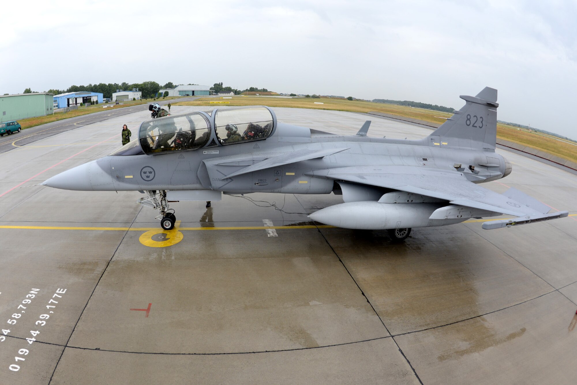 Hungarian and Swedish air force JAS-39 Gripen pilots board their jet June 24, 2015, during air refueling familiarization training on Kecskemét air base, Hungary. Hungarian, U.S. and Swedish air force personnel met for a two-week familiarization period enabling the Hungarian JAS-39 Gripen pilots to successfully perform air refueling for the first time. (U.S. Air Force photo by Senior Airman Kate Thornton/Released)