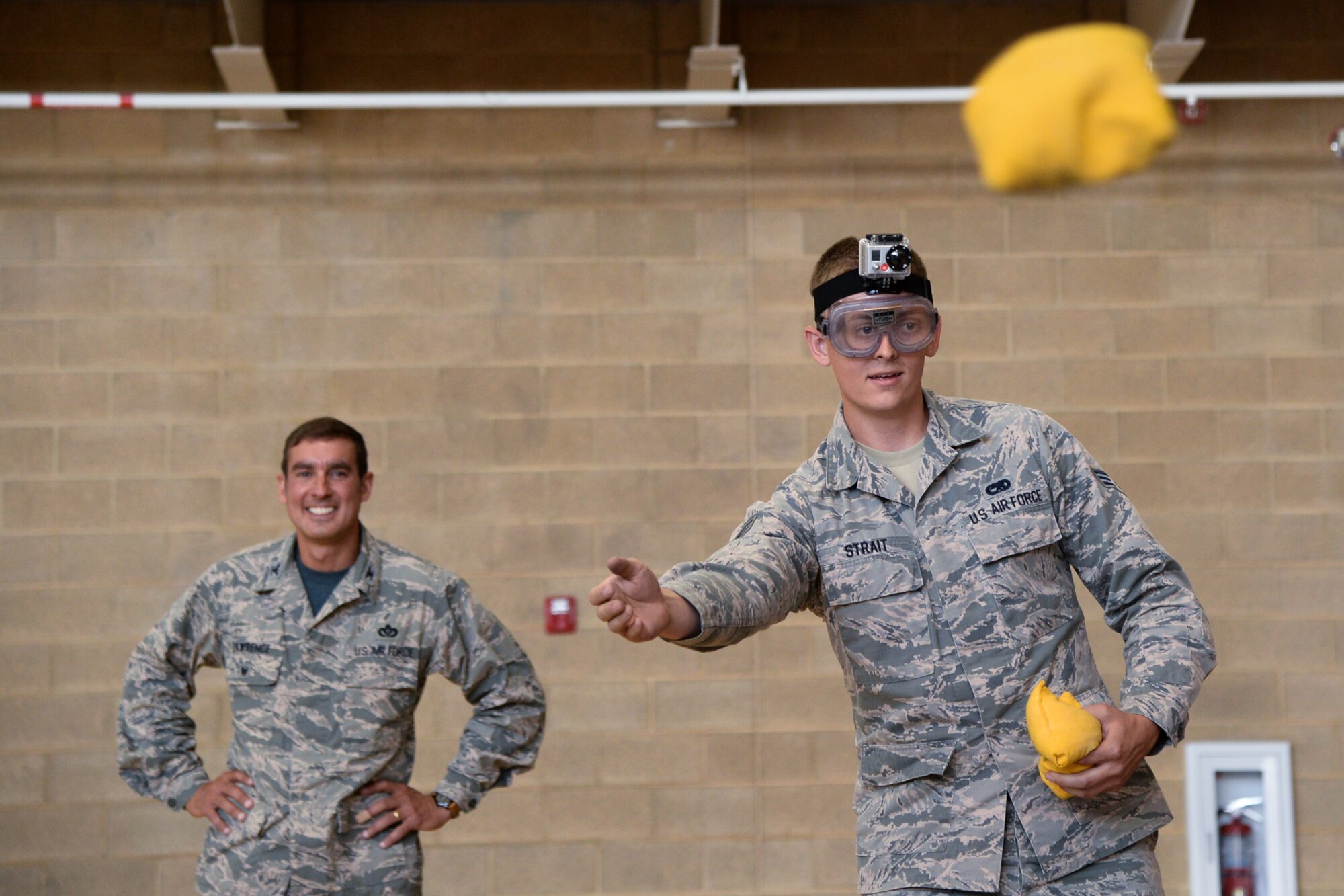 Senior Airman Kyle Strait, 388th Component Maintenance Squadron, tosses a bean bag while wearing “impairment goggles” that simulate inebriation during an Airmen Against Drunk Driving awareness event at the Warrior Fitness Center June 26. The base’s AADD program offers Airmen a free ride if they’ve had too much to drink. (R. NIAL BRADSHAW/U.S. Air Force)