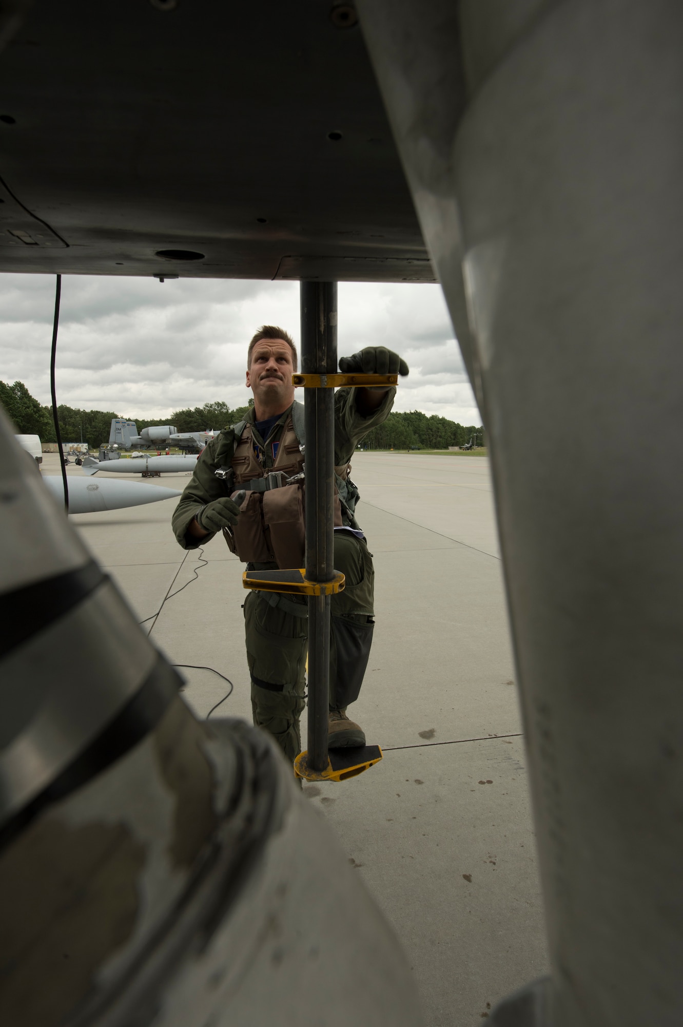 A U.S. Air Force 354th Expeditionary Fighter Squadron pilot climbs into an A-10 Thunderbolt II attack aircraft during a theater security package deployment at Lask Air Base, Poland, July 10, 2015. The U.S. Air Force's forward presence in Europe allows Airmen to work with allied and partner nations to develop and improve ready air forces capable of maintaining regional security. (U.S. Air Force photo by Staff Sgt. Christopher Ruano/Released)
