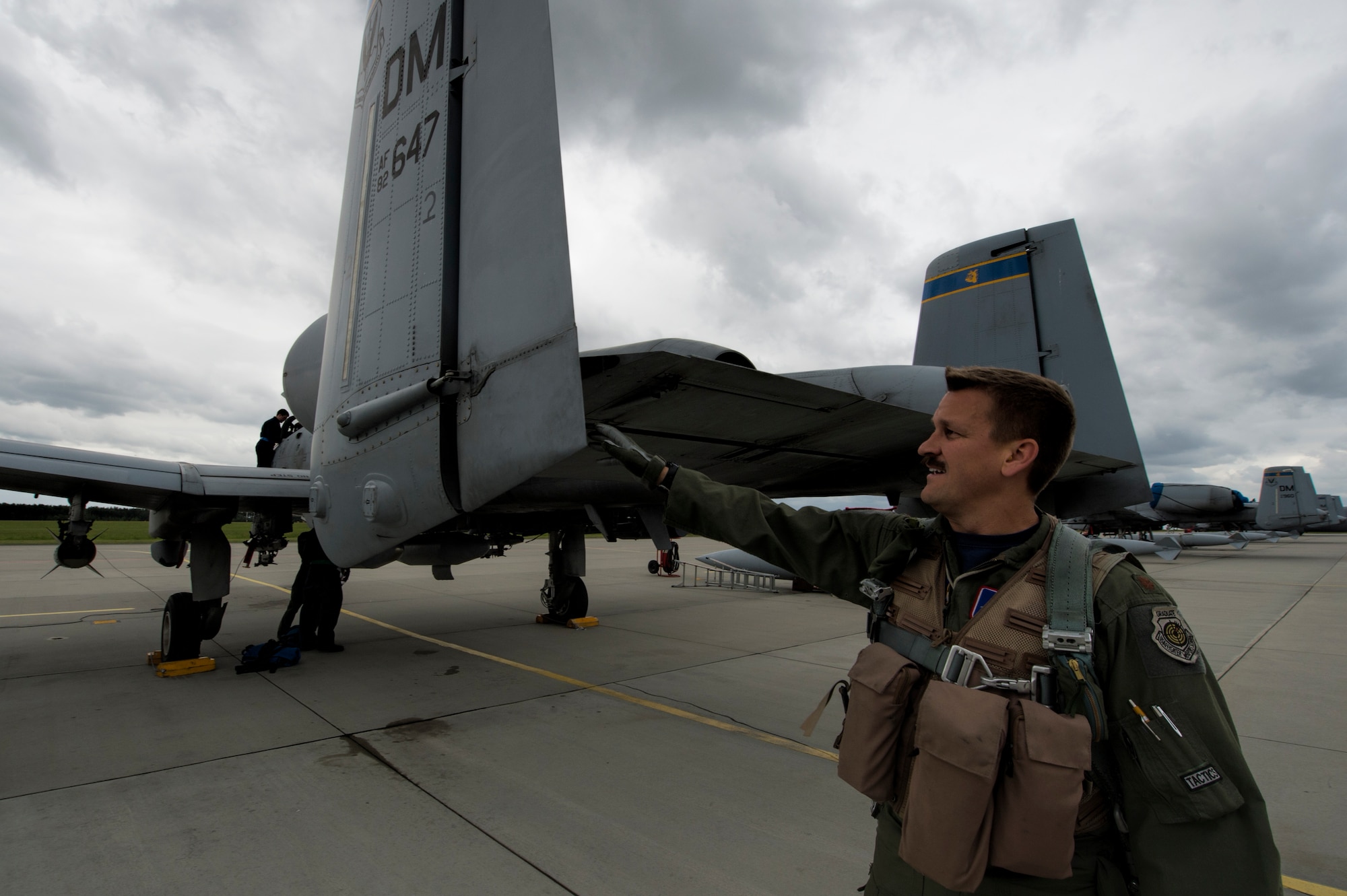A U.S. Air Force 354th Expeditionary Fighter Squadron A-10 Thunderbolt II attack aircraft pilot performs a walk-around before flight during a theater security package deployment at Lask Air Base, Poland, July 10, 2015. Pilots and crew chiefs perform pre- and post-flight inspections on the aircraft to ensure it is safe to fly. (U.S. Air Force photo by Staff Sgt. Christopher Ruano/Released)