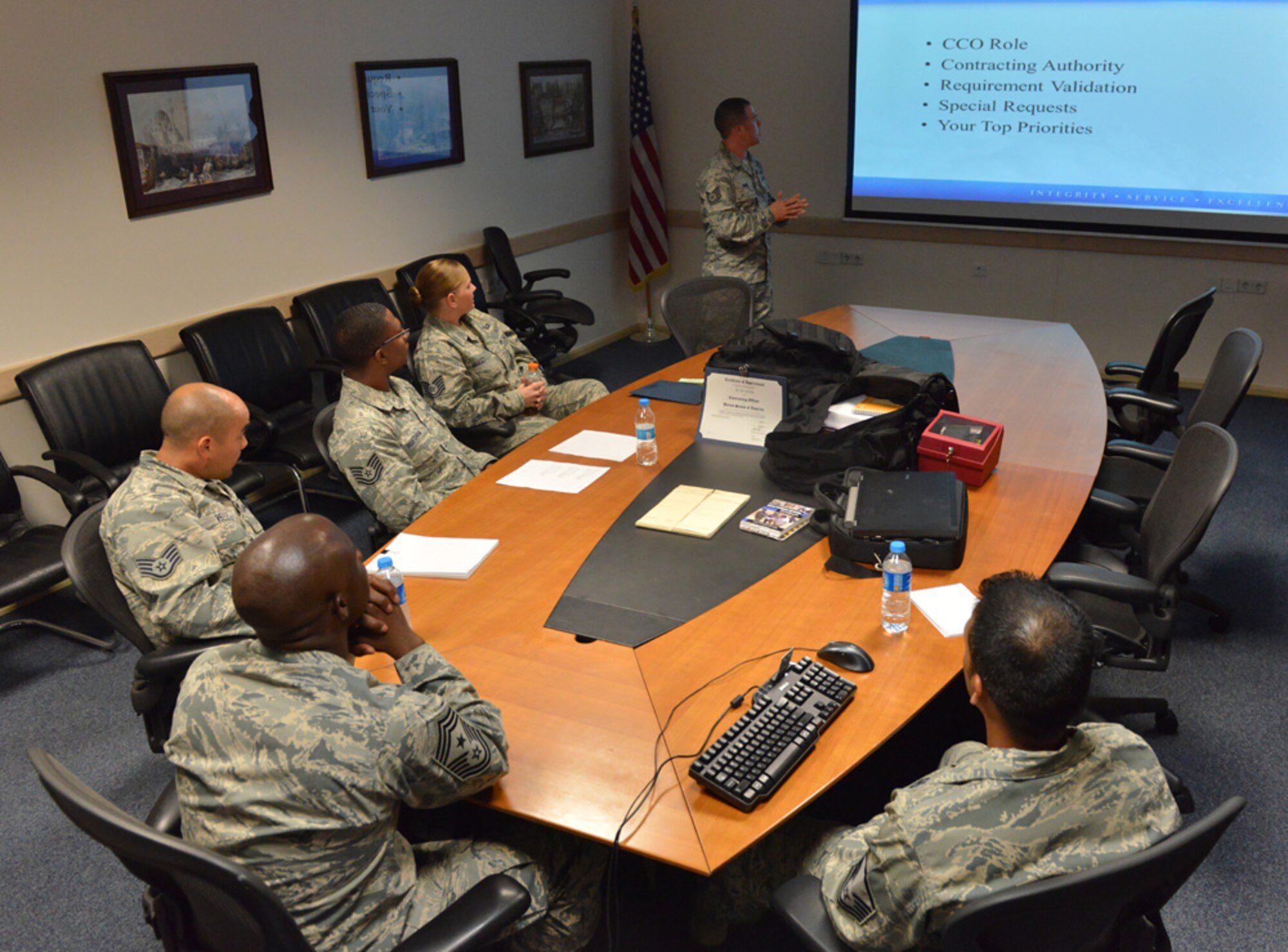 Tech. Sgt. Seth Shan, 39th Contracting Squadron contract officer, briefs Chief Master Sgt. Vegas Clark, 39th Air Base Wing command chief, during a unit visit July 9, 2015, at Incirlik Air Base, Turkey. Each week, Clark meets with Airmen from different units and offices across Team Incirlik to better understand their jobs. (U.S. Air Force photo by Senior Airman Michael Battles/Released)