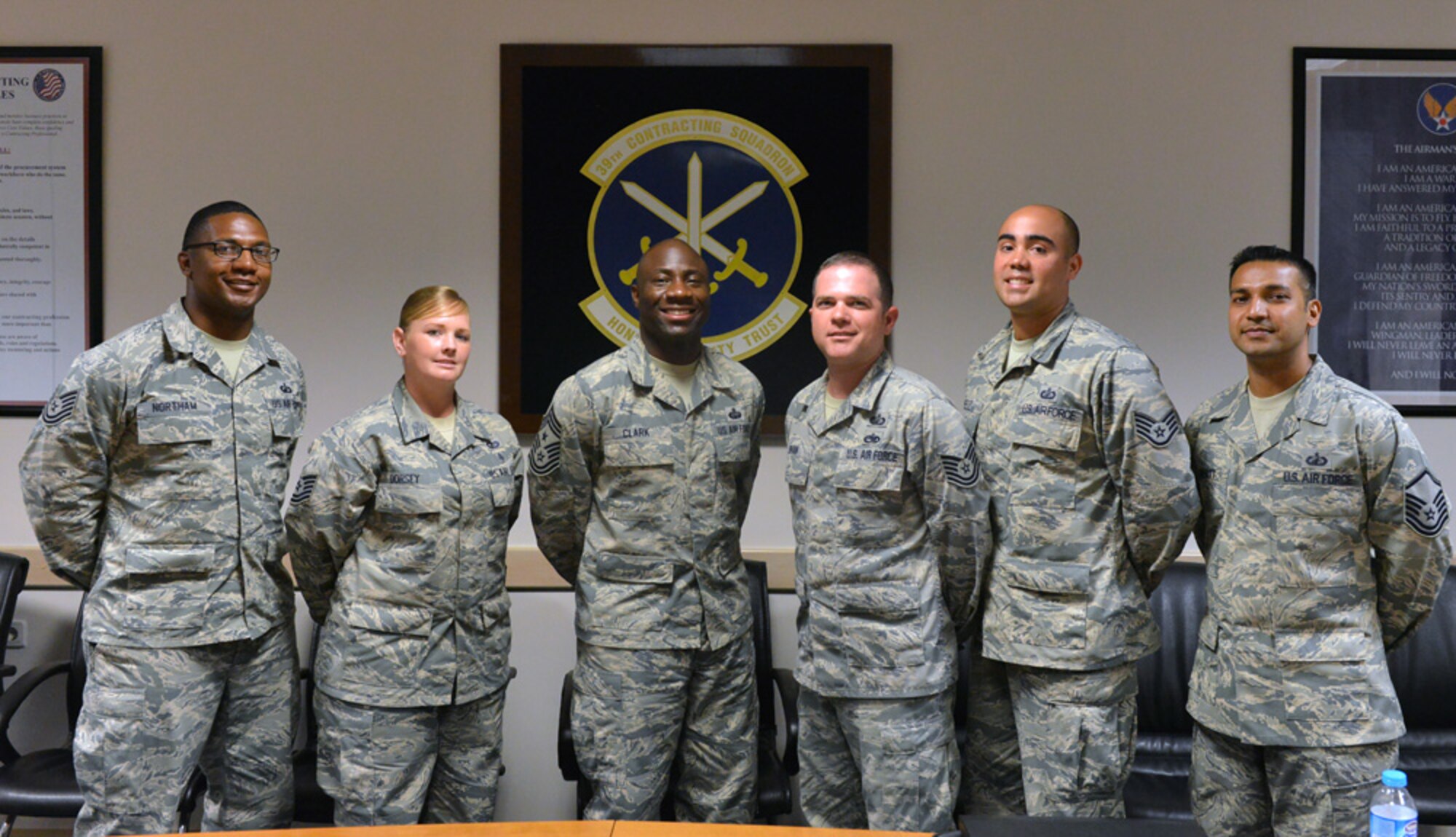 Members of the 39th Contracting Squadron team poses with Chief Master Sgt. Vegas Clark, 39th Air Base Wing command chief, during a unit visit July 9, 2015, at Incirlik Air Base, Turkey. Clark met with Airmen of the 39th CONS as part of the commander’s Out Connecting with Airmen Program. (U.S. Air Force photo by Senior Airman Michael Battles/Released)