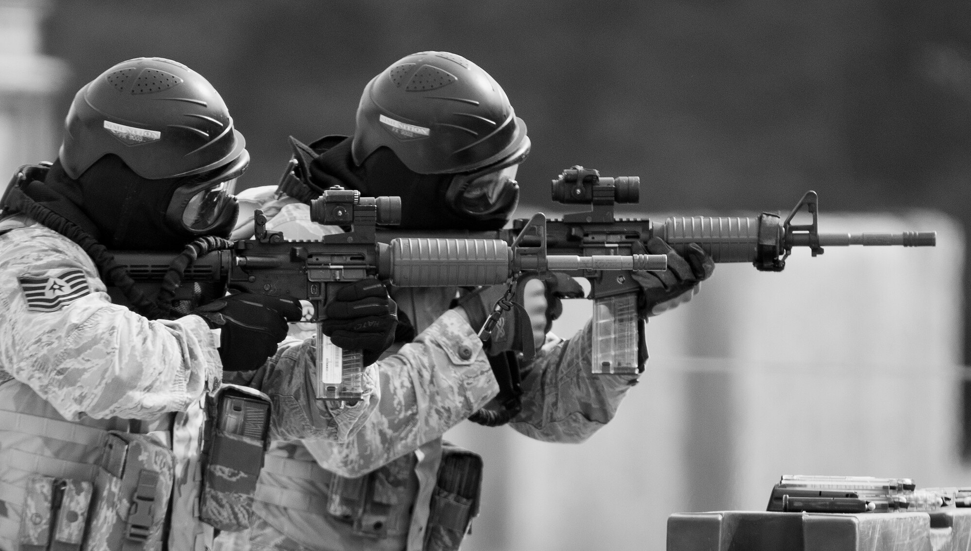 Airmen with the 96th Security Forces Squadron take aim downrange during a shoot, move and communicate drill at Eglin Air Force Base, Fla.  The mandatory training requirement is in addition to annual weapons qualification training.  The exercise consists of Airmen firing simmunition ammo while advancing toward, away from and to the side of a target.  This is followed by a building sweep and clear drill.  The Defenders perform the highly kinetic training at Eglin’s Base Tango range.  The range was previously used for security forces pre-deployment training.  (U.S. Air Force photo/Samuel King Jr.)