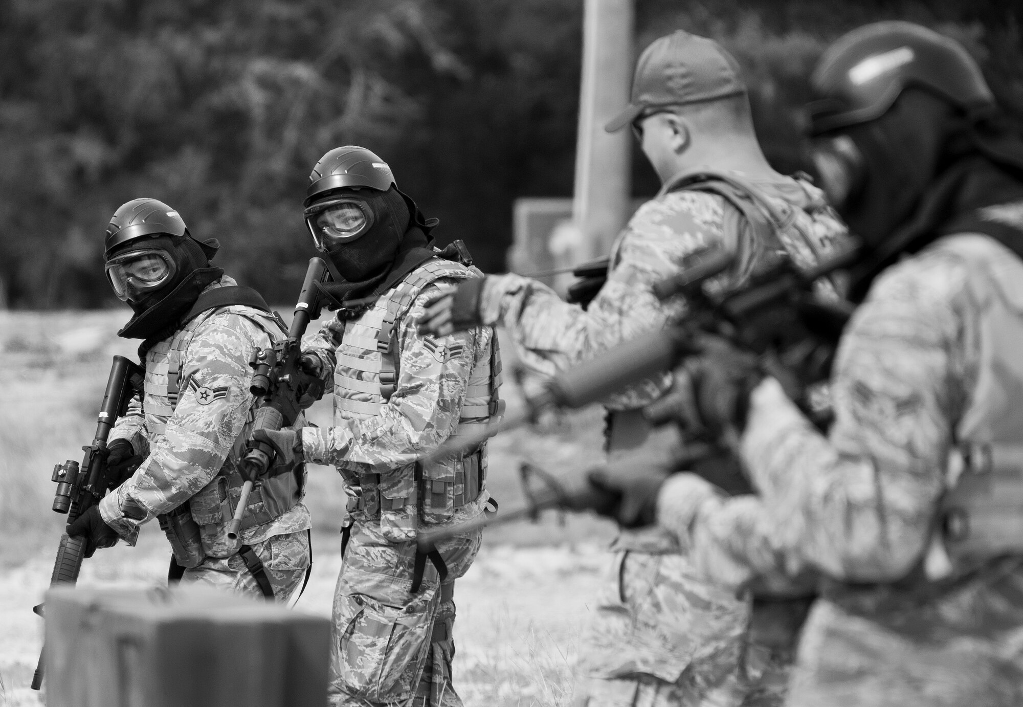 A 96th Security Forces Squadron instructor explains the shoot, move and communicate drill procedures to a team of Airmen prior to the exercise at Eglin Air Force Base, Fla.  The mandatory training requirement is in addition to annual weapons qualification training.  The exercise consists of Airmen firing simmunition ammo while advancing toward, away from and to the side of a target.  This is followed by a building sweep and clear drill.  The Defenders perform the highly kinetic training at Eglin’s Base Tango range.  The range was previously used for security forces pre-deployment training.  (U.S. Air Force photo/Samuel King Jr.)