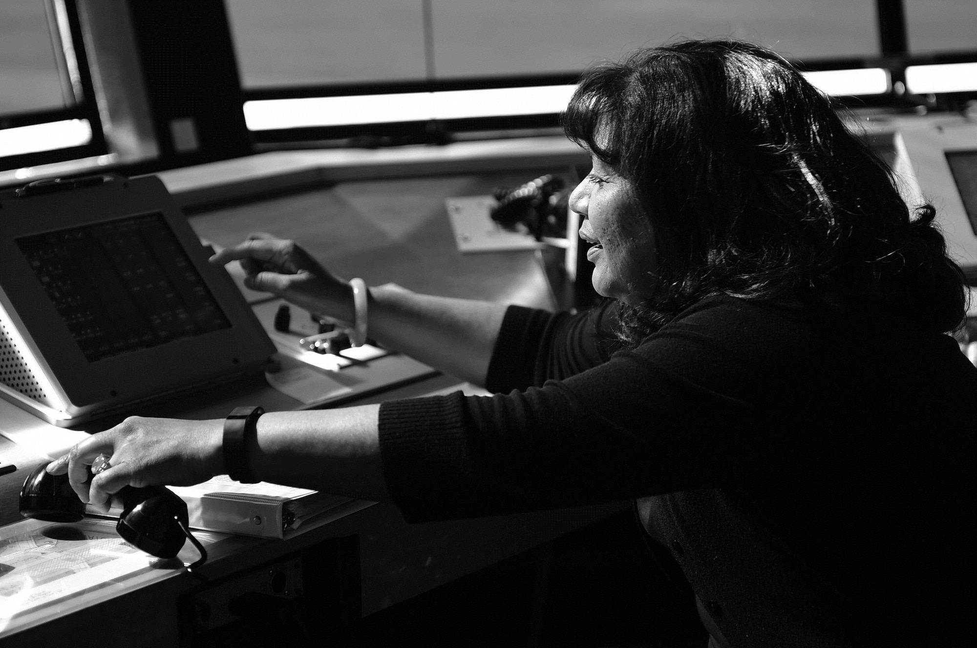 Zelda Montoya, 422nd Air Base Group air traffic manager, coordinates control tower operations during a training exercise at RAF Fairford, United Kingdom, June 4, 2015. Montoya said the stress often associated with life as an air traffic controller is mitigated by the close-knit relationships she has formed during more than 35 years in the career field. (U.S. Air Force photo by Tech. Sgt. Chrissy Best/Released)