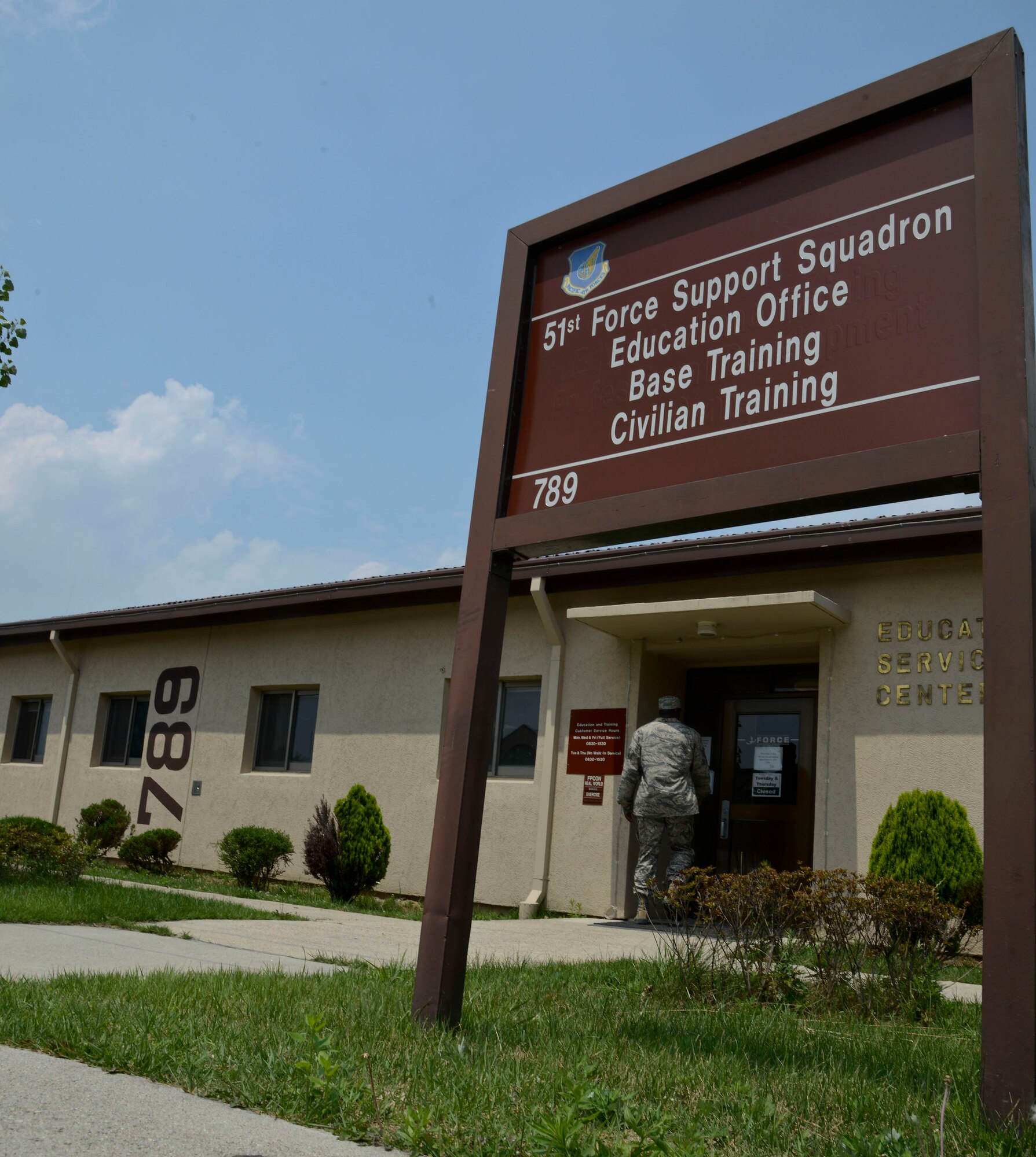 An Airman enters the education and services center in building 789 on Osan Air Base, Republic of Korea, July 2, 2015. The center offers assistance with education, training, formal training and various types of military testing. The base education and services center has 10 individuals who assist with various aspects of military and personal growth. They are also responsible for the education and training of all U.S. military and civilian employees on the peninsula. (U.S. Air Force photo/Senior Airman Kristin High)