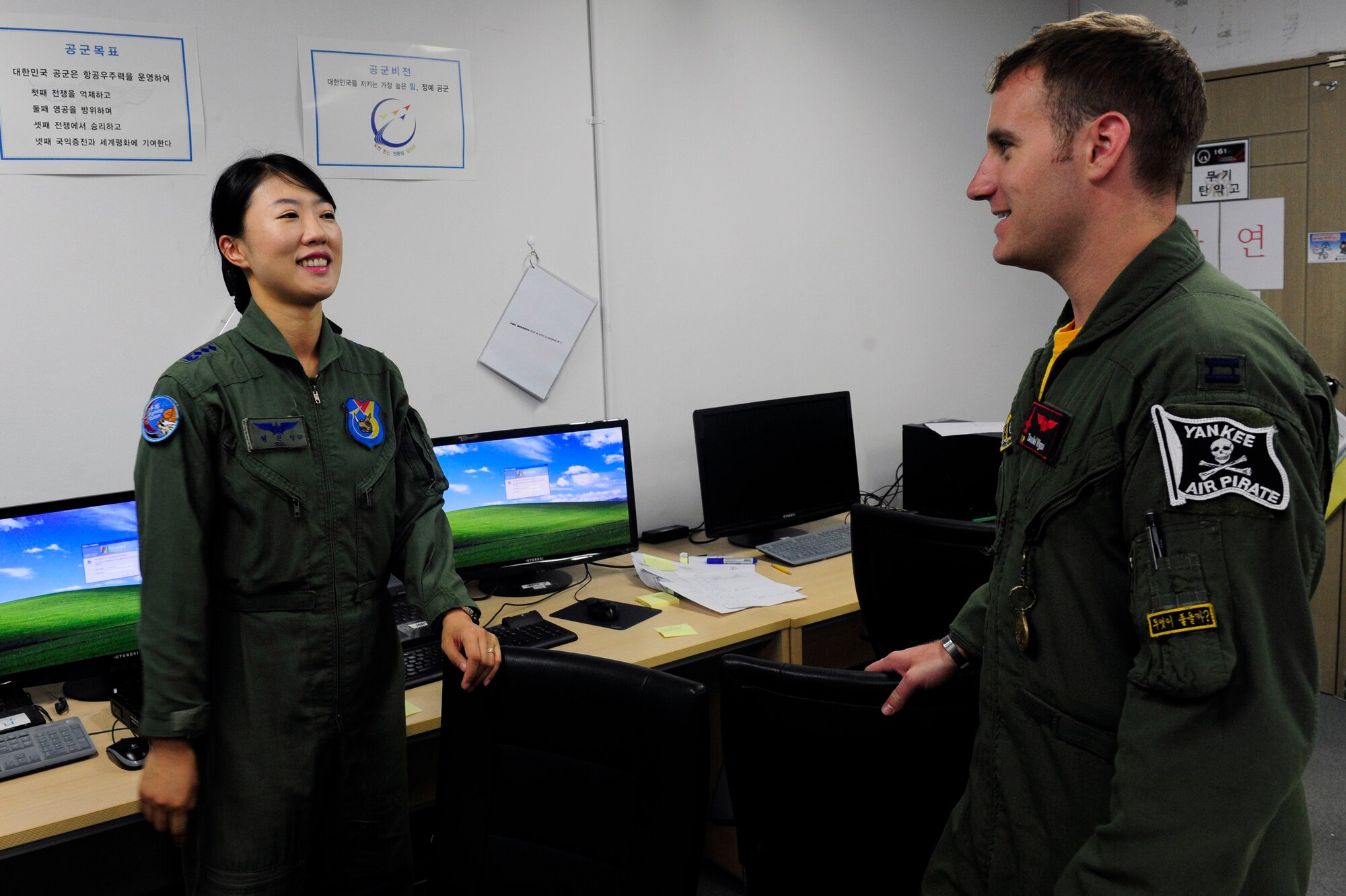 Republic of Korea Air Force Capt. Jin-Young Seol, 19th Fighter Wing KF-16 Fighting Falcon pilot, converses with U.S. Air Force Capt. Daniel Wynn, 80th Fighter Squadron assistant director of operations, Kunsan Air Base, Republic of Korea, at Jungwon Air Base, , ROK, during Buddy Wing 15-6, July 8, 2015. In an effort to enhance U.S. and ROKAF air combat capability, Buddy Wing exercises are conducted multiple times throughout the year on the peninsula to sharpen interoperability between the allied forces so that if need be, they are always ready to fight as a combined force. (U.S. Air Force photo by Staff Sgt. Nick Wilson/Released)