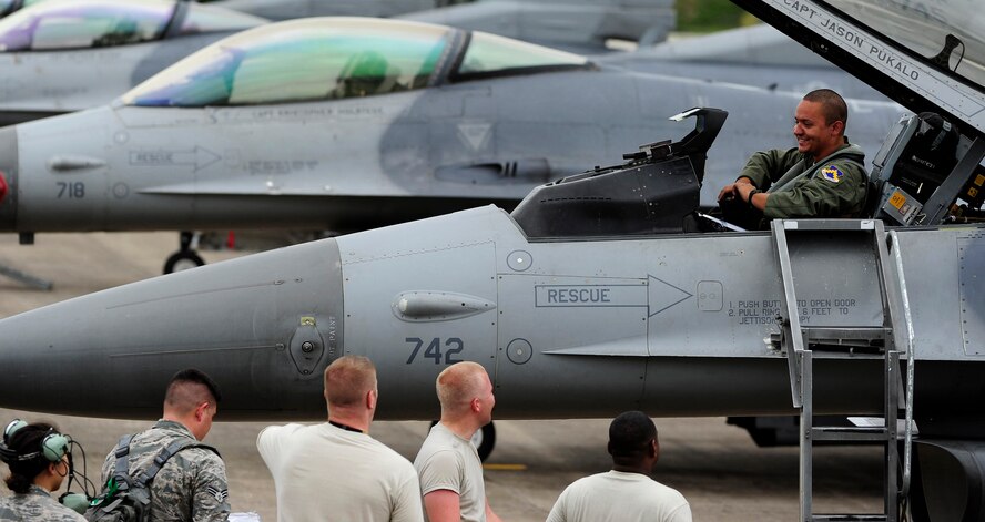 1st Lt. Bryce Turner, 80th Fighter Squadron F-16 Fighting Falcon pilot, Kunsan Air Base, Republic of Korea, talks with Airmen from the 80th Aircraft Maintenance Unit upon arrival to Jungwon Air Base, ROK, during Buddy Wing 15-6, July 8, 2015. In an effort to enhance U.S. and ROKAF air combat capability, Buddy Wing exercises are conducted multiple times throughout the year on the peninsula to sharpen interoperability between the allied forces so that if need be, they are always ready to fight as a combined force. (U.S. Air Force photo by Staff Sgt. Nick Wilson/Released)