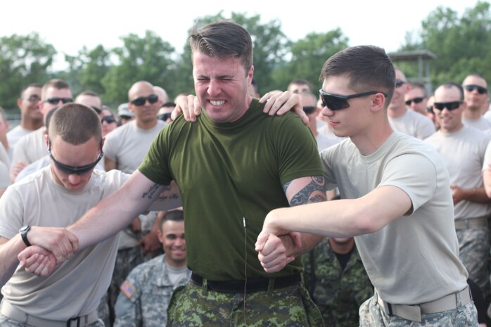 U.S. Army Reserve, and Canadian soldiers volunteer to feel the effects of the Taser after completing the practical portion of the Taser training during Operation Guardian Justice in Fort McCoy, Wis., June 10,2015. (U.S. Army Reserve Photo by Spc. Stephanie Ramirez/Released)