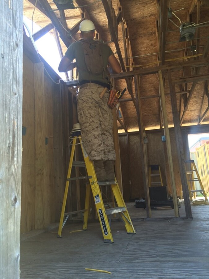 A Marine from BE 6-15 works on wiring.