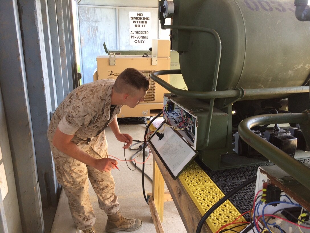 A Marine from BEEEST 7-15 conducts a practical application on the electrical system of an M-80 water heater.