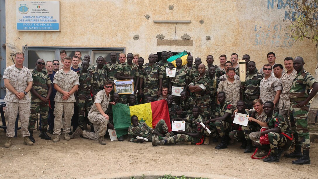 Marines, sailors and coast guardsmen assigned to Special-Purpose Marine Air-Ground Task Force Crisis Response-Africa and members of the Compagnie Fusilier de Marin Commandos pose for a picture after a graduation ceremony in St. Louis, Senegal, July 9, 2015. More than 30 members of the Fusilier Marins graduated a nearly six-week long maritime security force assistance training course, where the U.S. service members taught the Senegalese small-boat operations and light infantry skills. 