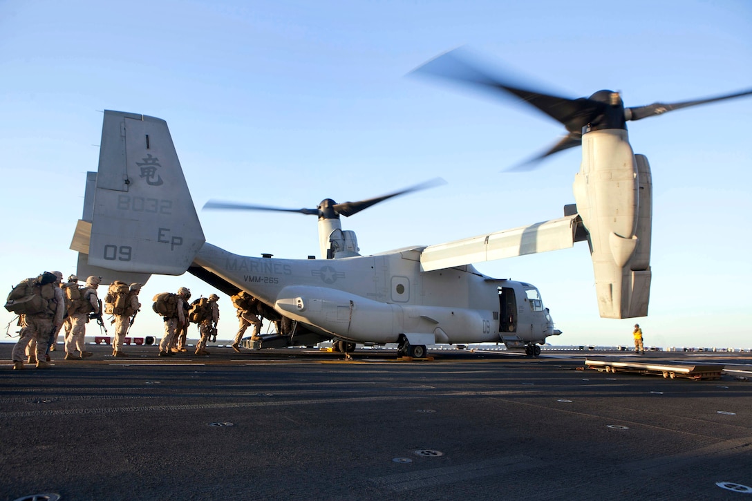 U.S. Marines board an MV-22 Osprey during an amphibious assault as part ...