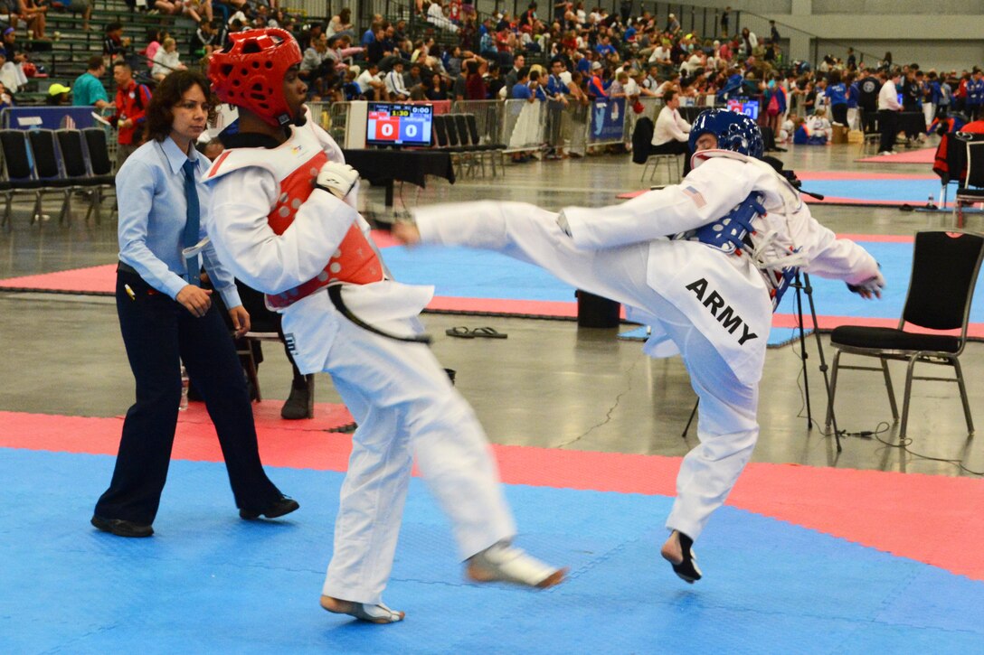 Army Sgt. Michael Warner, right, tries to score on his opponent with a ...