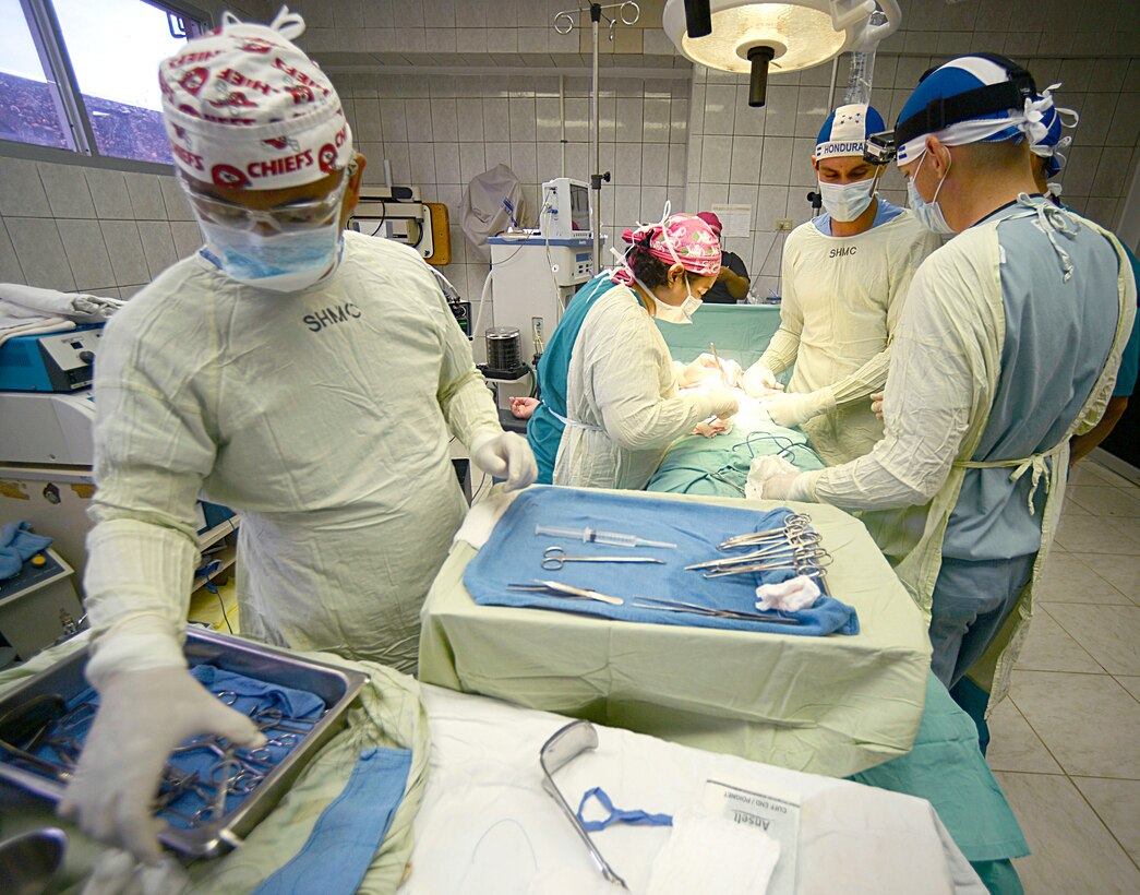U.S. Air Force and Honduran doctors work together to perform hernia surgery on a patient at the Doctor Salvador Paredes Hospital in Trujillo, Honduras, July 2, 2015. 