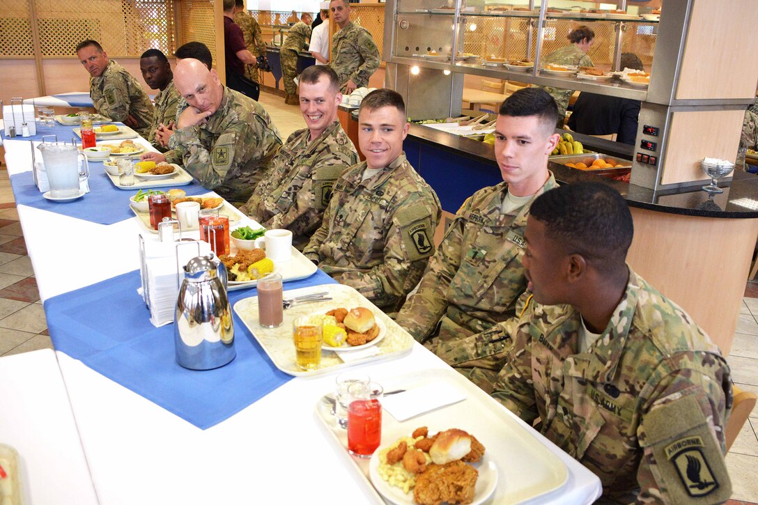 U.S. Army Chief of Staff Gen. Ray Odierno, fourth from left, talks to soldiers during lunch at the Stryker Inn dining facility on Rose Barracks in Vilseck, Germany, July 9, 2015.