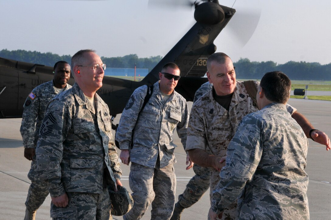Air Force Col. Craig Baker, right, commander of the 180th Fighter Wing, greets Marine Corp Sgt. Maj. Bryan Battaglia, senior enlisted advisor to the chairman of the Joint Chiefs of Staff,  on Toledo Air National Guard Base in Swanton, Ohio, July 11, 2015. During Battaglia's visit, he toured the Aerospace Control Alert facility, met with key personnel, and hosted an informal town hall and luncheon for enlisted airmen.