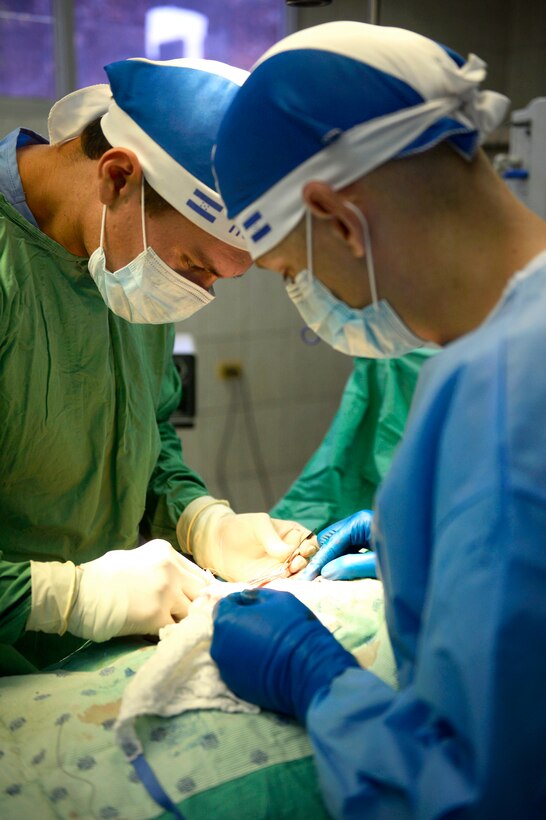 U.S. Air Force Maj. Ryan Jones teaches Dr. Raul Alfredo Castellanos, a Honduran medical student, how to suture the skin after a surgery in the operating room at Doctor Salvador Paredes Hospital in Trujillo, Honduras, July 2, 2015. Jones is a general surgeon assigned to the 56th Medical Operations Squadron.