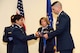 Col. Beena Maharaj, the 403rd Mission Support Group commander assists Maj. Quinton Sasnett, the outgoing 403rd Civil Engineering Squadron commander with a casing the colors event during the 403rd CES inactivation ceremony at Keesler Air Force Base July 12. (U.S. Air Force photo)
