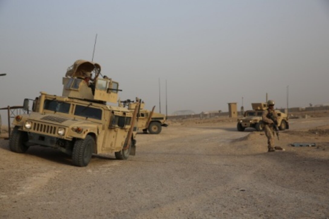 U.S. Marines come to a security halt during a patrol at Al Taqaddum Air Base, Iraq, July 3, 2015. The Task Force Al Taqaddum Security Force runs regular mounted and dismounted patrols of the area to ensure the safety of the Al Taqaddum personnel. Task Force Al Taqaddum is part of Operation Inherent Resolve’s Advise & Assist mission, which places U.S. coalition members in mentorship positions with Iraqi Security Force leadership in subjects like logistics and operations planning. (U.S. Marine Corps photo by Cpl. John Baker)