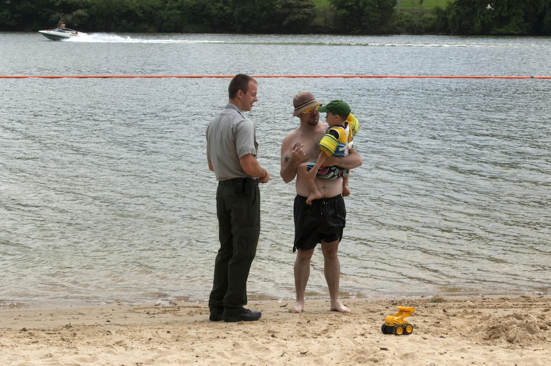 Park Ranger Phillip Sliger gives a voucher for a free ice cream from McDonalds to Eero Kent, who wore a life jacket while swimming at Cordell Hull Lake July 9, 2015 with his father Greg and mother Crystal. The sweet treat was courtesy of the McDonalds in Gordonsville, Tenn.