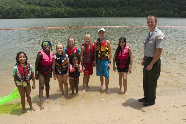 Park Ranger Phillip Sliger poses with a group of kids wearing their life jackets at Defeated Creek Park Day Use Area at Cordell Hull Lake July 9, 2015.  They all received vouchers good for a free ice cream treat or smoothie courtesy of the McDonalds in Gordonsville, Tenn.