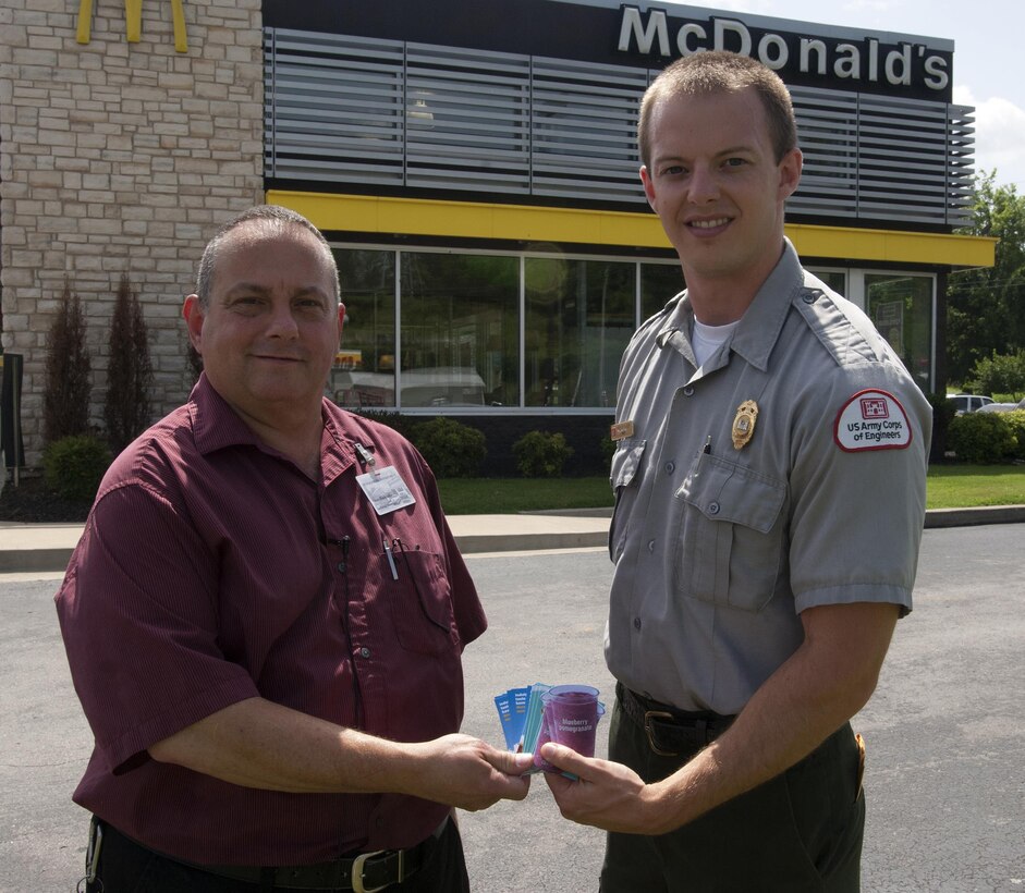 Park Ranger Phillip Sliger (Right) receives vouchers for free ice cream and smoothies July 9, 2015 from Vince Blackledge, general manager of the McDonalds in Gordonsville, Tenn. The owners, Tim and Sandra Funderburk, donated the vouchers to promote positive family recreation and reward kids who practice good safety.