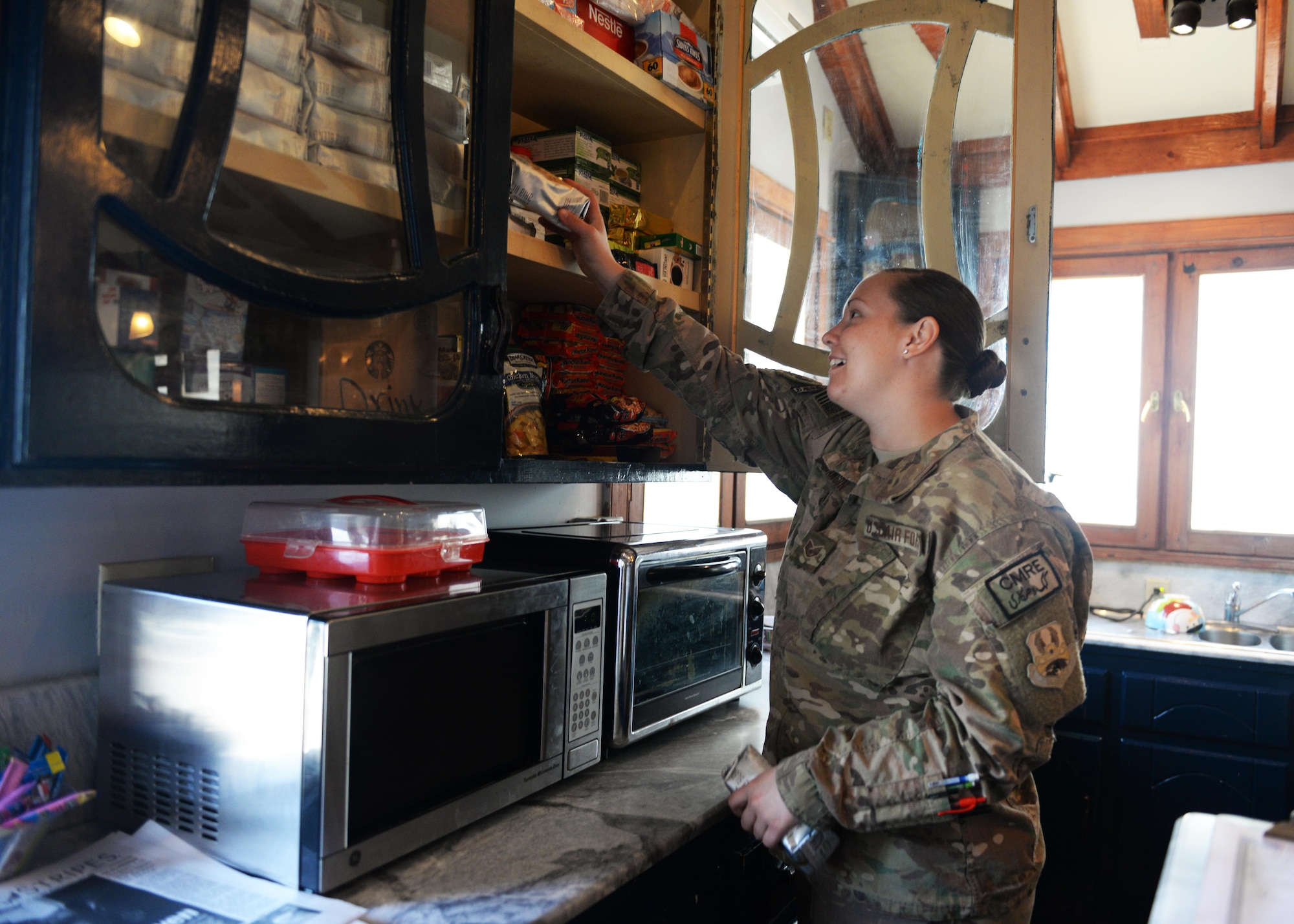 U.S. Staff Sgt. Sabrina Dawson, 455th Expeditionary Logistics Readiness Squadron air transportation apprentice, stocks snacks in the Pat Tillman Memorial Center USO July 14, 2015, at Bagram Airfield, Afghanistan. The Bagram USO is a facility for military members to go and relax in a comfortable environment as well as make free phone calls to loved ones.(U.S. Air Force photo by Senior Airman Cierra Presentado/Released)