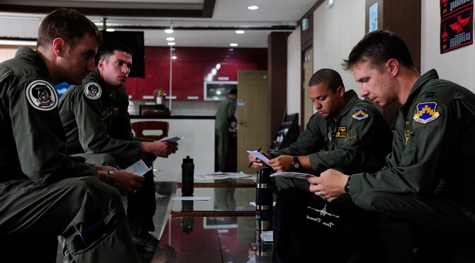 F-16 Fighting Falcon pilots from the 80th Fighter Squadron at Kunsan Air Base, South Korea, review and discuss flight procedures at Jungwon Air Base, South Korea, during Buddy Wing 15-6, July 9, 2015. Buddy Wing exercises are conducted multiple times throughout the year to sharpen interoperability between U.S. and South Korean forces so, if the need arises, they are always ready to fight as a combined force. (U.S. Air Force photo/Staff Sgt. Nick Wilson)