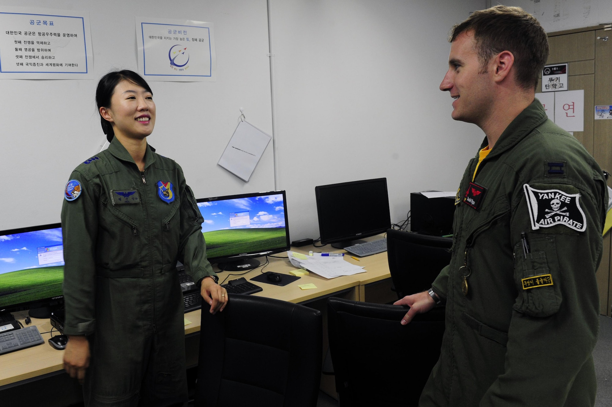 South Korean air force Capt. Jin-Young Seol, a 19th Fighter Wing KF-16 Fighting Falcon pilot, talks to Capt. Daniel Wynn, the 80th Fighter Squadron assistant director of operations, at Jungwon Air Base, South Korea, during Buddy Wing 15-6, July 10, 2015. Buddy Wing exercises are conducted multiple times throughout the year to sharpen interoperability between U.S. and South Korean forces so, if the need arises, they are always ready to fight as a combined force. (U.S. Air Force photo/Staff Sgt. Nick Wilson) 