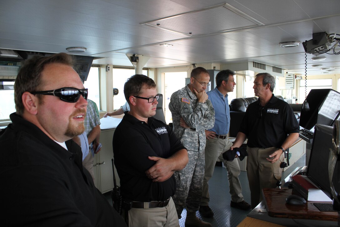 Col. William H. Graham, commander of the U.S. Army Corps of Engineers' North Atlantic Division speaks with the officers and crew aboard the McFarland, a deep draft hopper dredge owned and operated by the USACE Philadelphia District, during a tour on June 30, 2015. 