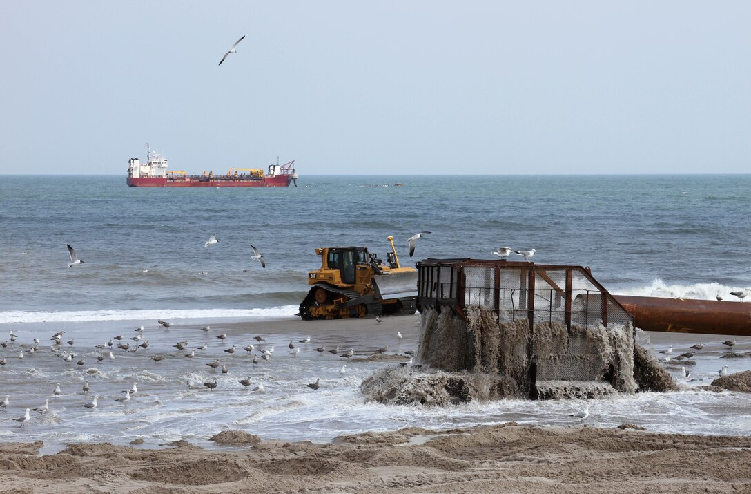 The U.S. Army Corps of Engineers' Philadelphia District and its contractor Great Lakes Dredge & Dock Company are pumping approximately 8 million cubic yards of sand onto Long Beach Island, N.J. The Dredge Dodge Island is shown in the distance. Work is designed to complete the dune and berm system and reduce future storm damages. The project is the result of a partnership between USACE and the New Jersey Department of Environmental Protection. 