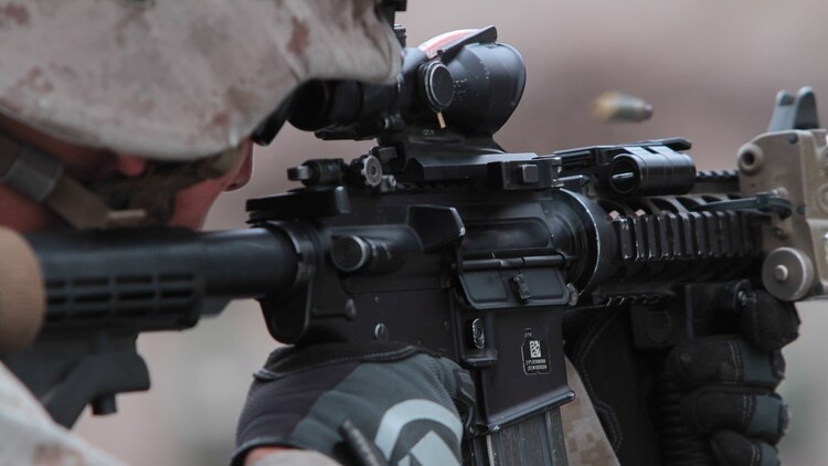 Lance Cpl. Justin Ezell, a Marine with 2nd Battalion, 1st Marine Division, I Marine Expeditionary Force, shoots at his target during Special Operations Training Group’s Raid Leaders Course at Marine Corps Base Camp Pendleton, California, June 9, 2015. The two-week long course focuses on preparing Marines to conduct combat raids. 
