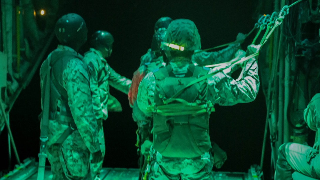 Marines with 1st Radio Battalion, I Marine Expeditionary Force, prepare to conduct a parachute drop out of a KC-130J Super Hercules at Marine Corps Base Camp Pendleton, California, July 8. Marines with Marine Aerial Refueler Transport Squadron 352 assisted the battalion with the parachute drop.