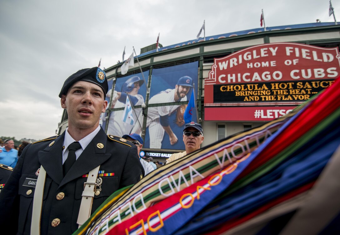 Spc. Travis Gantz, an Army Reserve color guard team member from the 416th Theater Engineer Command, carries the U.S. Army flag after presenting colors at Wrigley Field for a Chicago Cubs game against the Los Angeles Dodgers, June 25. The 416th TEC is headquartered just 30 miles driving distance from Wrigley Field and is responsible for more than 12,000 Army Reserve Soldiers in 27 different states. The color guard team members were Staff Sgt. John Pudowski, Staff Sgt. Timothy Cooper, Sgt. Peter Garcia, Spc. William McGuigan and Spc. Travis Gantz. (U.S. Army photo by Master Sgt. Michel Sauret)