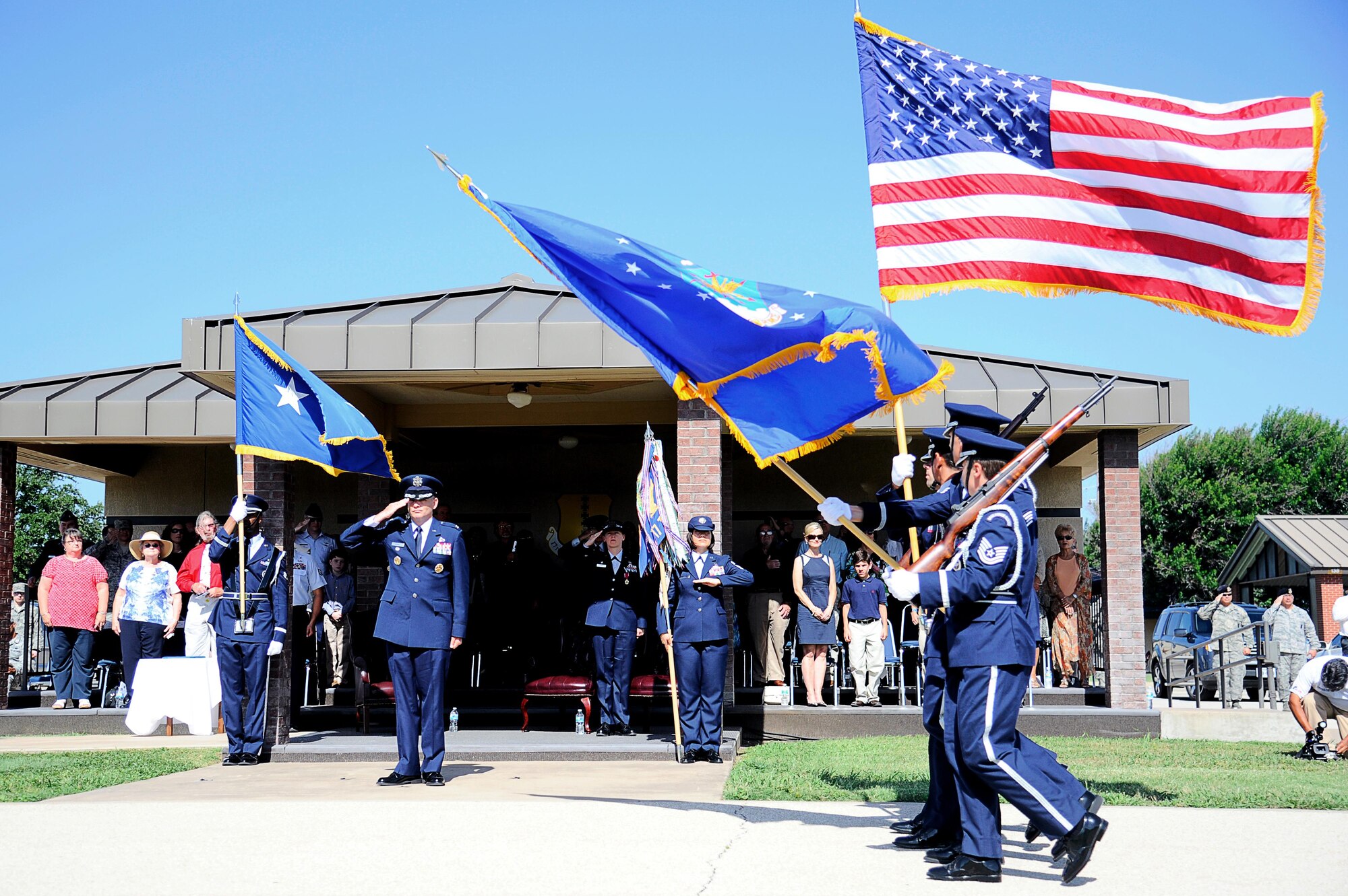U.S. Air Force Col. Michael L. Downs, 17th Training Wing Commander, salutes the colors after assuming command during the 17th TRW Change of Command Ceremony at the parade field on Goodfellow Air Force Base, Texas, July 14, 2015. Col. Kimberlee P. Joos relinquished command to Downs, who is the 45th commander of Goodfellow. (U.S. Air Force photo by Tech. Sgt. Austin Knox/Released)  