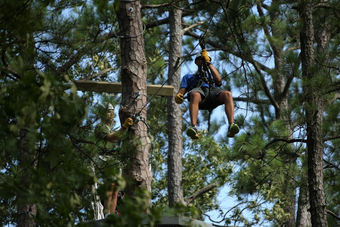 Lt. Col. Eric Austin, left, and Lt. Col. Bryan Horvath maneuver through obstacles in the tree line while participating in the Devil Dog Dare at Marine Corps Air Station Cherry Point, N.C., July 10, 2015. The Devil Dog Dare is a part of Operation Adrenaline Rush, a Marine Corps-wide program designed to teach Marines how to deal with every day stress in positive ways. Austin is the commanding officer of Marine Aircraft Group 14 and Horvath is the commanding officer of Marine Aviation Logistics Squadron 14. (U.S. Marine Corps photo by Cpl. N.W. Huertas/ Released)