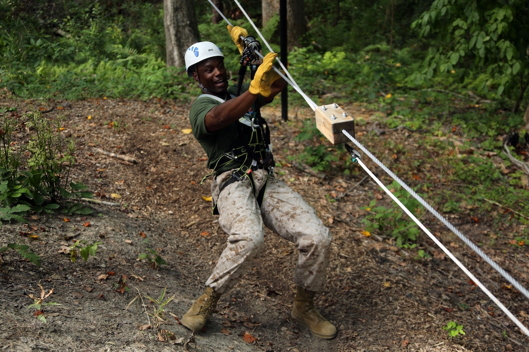 Sgt. Maj. Jermaine Jenkins maneuvers through obstacles in the tree line while participating in the Devil Dog Dare at Marine Corps Air Station Cherry Point, N.C., July 10, 2015. The Devil Dog Dare is a part of Operation Adrenaline Rush, a Marine Corps-wide program designed to teach Marines how to deal with every day stress in positive ways. Jenkins is the Sgt. Maj. of Marine Wing Support Squadron 271. (U.S. Marine Corps photo by Cpl. N.W. Huertas/ Released)