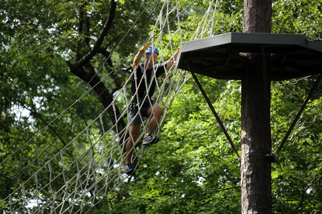 Sgt. Maj. Brandon Eckardt maneuvers through obstacles in the tree line while participating in the Devil Dog Dare at Marine Corps Air Station Cherry Point, N.C., July 10, 2015. The Devil Dog Dare is a part of Operation Adrenaline Rush, a Marine Corps-wide program designed to teach Marines how to deal with every day stress in positive ways. Eckardt is the sergeant major of Marine Attack Squadron 542. (U.S. Marine Corps photo by Cpl. N.W. Huertas/ Released)