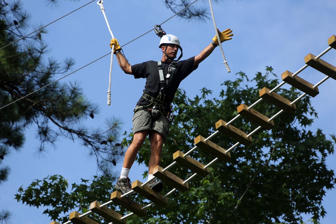 Sgt. Maj. Michael Johnson maneuvers through obstacles in the tree line while participating in the Devil Dog Dare at Marine Corps Air Station Cherry Point, N.C., July 10, 2015. The Devil Dog Dare is a part of Operation Adrenaline Rush, a Marine Corps-wide program designed to teach Marines how to deal with every day stress in positive ways.Johnson is the sergeant major of Marine Attack Training Squadron 203. (U.S. Marine Corps photo by Cpl. N.W. Huertas/ Released)