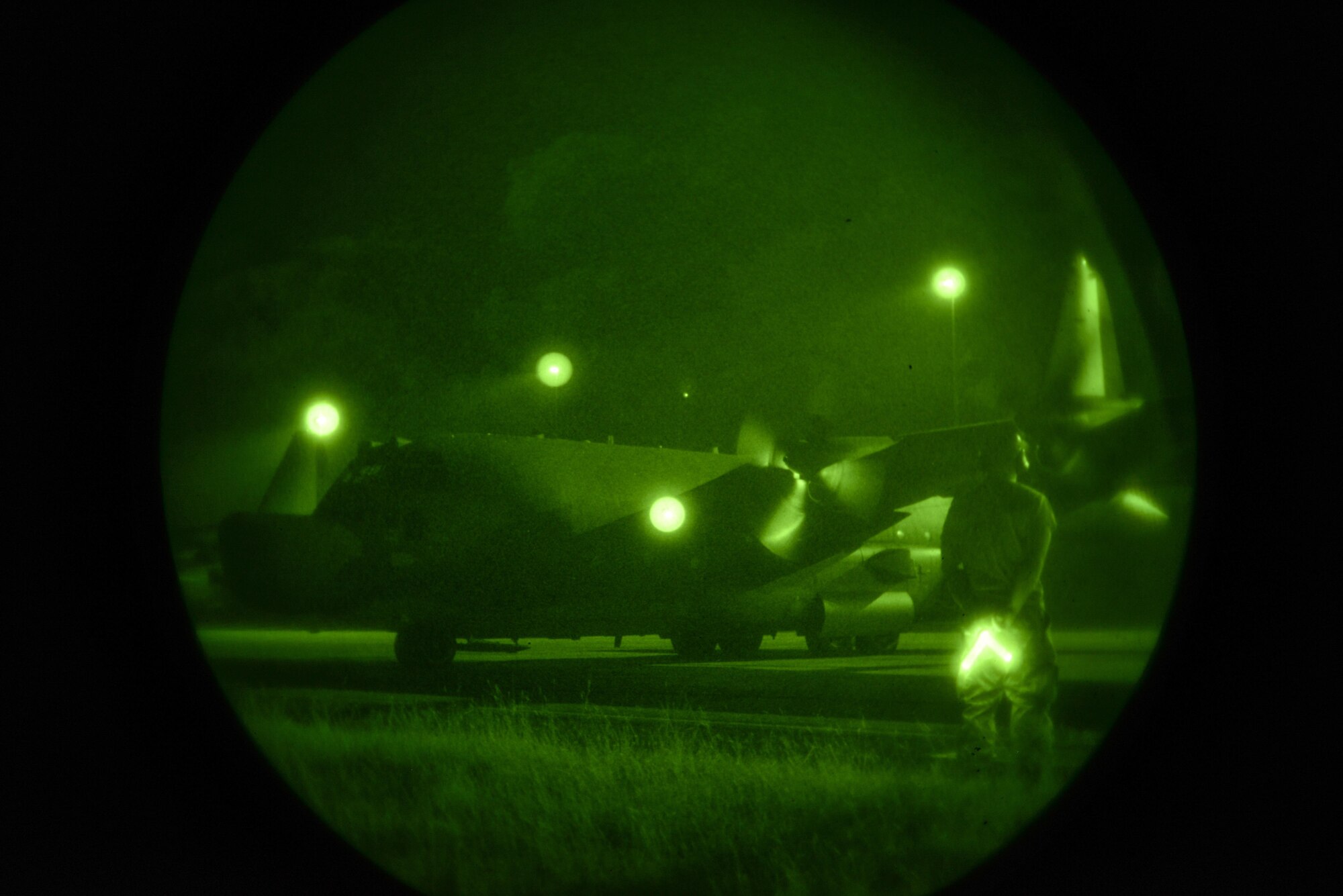 A crew chief from the 353rd Special Operations Maintenance Squadron prepares to marshal an MC-130H Combat Tallon II as they get ready for takeoff in the Northern Territory of Australia, July 1, 2015. Talisman Sabre provides an invaluable opportunity to conduct operations in a combined, joint, and interagency environment. (U.S. Air Force photo by Senior Airman Stephen G. Eigel)