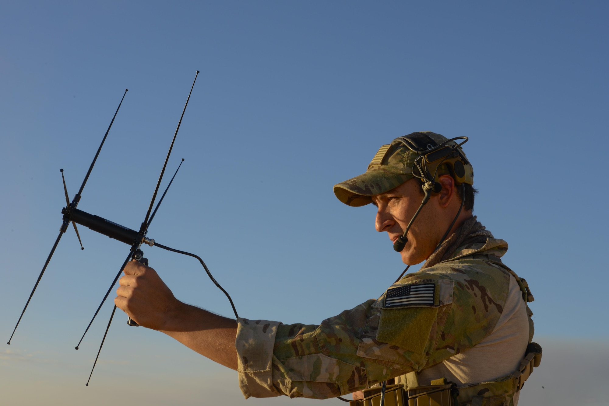 A U.S. Air Force combat controller from the 320th Special Tactics Squadron attempts to gain communication with U.S. and Australian partner units to establish a drop zone for equipment landing during exercise Talisman Sabre in the Northern Territory of Australia, June 29, 2015. The Australian-U.S. alliance continues to be a model of close cooperation and trust in the Indo-Asia-Pacific region. (U.S. Air Force photo by Senior Airman Stephen G. Eigel)